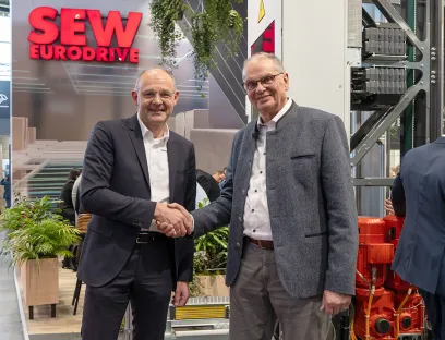 Dr. Hans Krattenmacher (left) of SEW-Eurodrive and Michael Wolter (right) of Safelog seal their partnership at Logimat to develop a software system for intralogistics